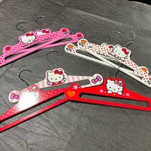 Hello Kitty Decorative Kids Hangers - Red, Pink, White. Seven wooden hangers.